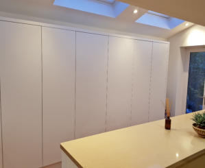 White handleless kitchen with oatmeal quartz worktops