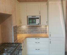 shaker kitchen with solid oak worktops built in microwave