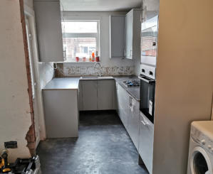 light grey Howdens kitchen with compact laminate worktops in Stockport