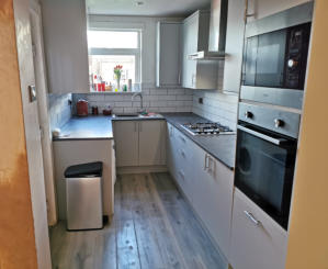 light grey Howdens kitchen with compact laminate worktops in Stockport