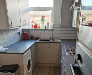 light grey Howdens kitchen with compact laminate worktops in Stockport