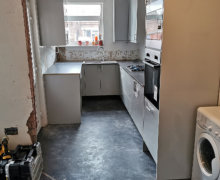 light grey Howdens kitchen with compact laminate worktops in Stockport