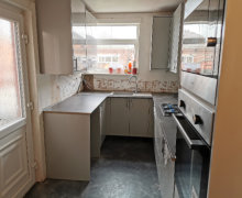 light grey Howdens kitchen with compact laminate worktops in Stockport