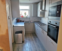 light grey Howdens kitchen with compact laminate worktops in Stockport