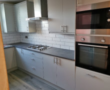 light grey Howdens kitchen with compact laminate worktops in Stockport