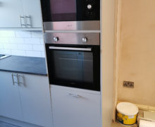 light grey Howdens kitchen with compact laminate worktops in Stockport