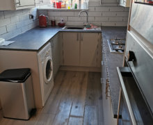 light grey Howdens kitchen with compact laminate worktops in Stockport