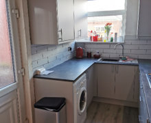 light grey Howdens kitchen with compact laminate worktops in Stockport