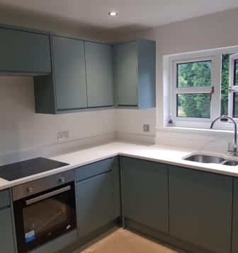 fjord green kitchen in Bramhall with white quartz worktops