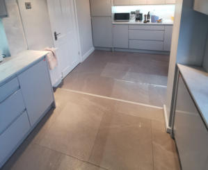 light grey handleless kitchen in Heald Green. Installed with grey quartz worktops