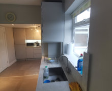 light grey handleless kitchen in Heald Green. Installed with grey quartz worktops