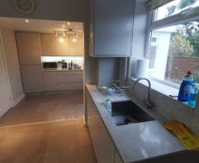 light grey handleless kitchen in Heald Green. Installed with grey quartz worktops