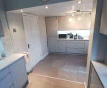 light grey handleless kitchen in Heald Green. Installed with grey quartz worktops