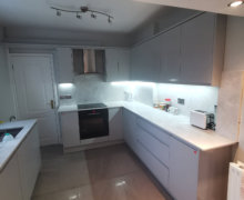 light grey handleless kitchen in Heald Green. Installed with grey quartz worktops