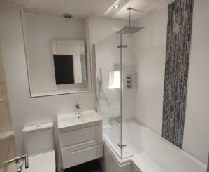 White bathroom wall tiles with wall mounted vanity unit.