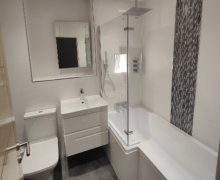 White bathroom wall tiles with wall mounted vanity unit.