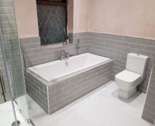 New bathroom in Bramhall. Grey metro wall tiles and small white hexagon floor tiles