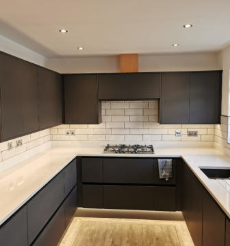 Dark grey kitchen with white quartz worktops in Stockport