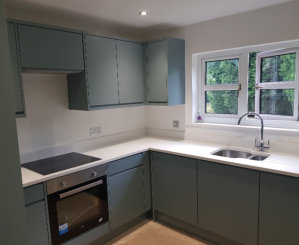 fjord green j pull handleless kitchen with white quartz worktops