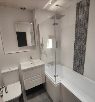 All white bathroom with mosaic over bath