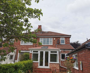 new red solid conservatory roof in Woodsmoor, Stockport