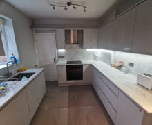 light grey j pull handleless kitchen with quartz worktops