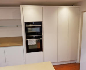 White handleless kitchen with oatmeal quartz worktops